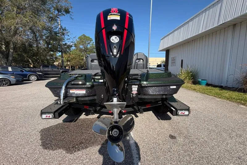 Slide: The Image of 2027 Nitro Z18 XL boat with powerful outboard motor, parked outdoors. - 6