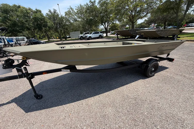 The Image of 2027 Tracker Grizzly 1648 Utility boat on trailer in parking lot. - 0