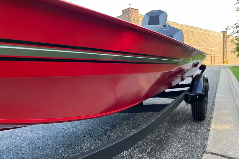 Slide: The Image of 2027 Tracker Bass Tracker Classic XL boat in vibrant red on a trailer. - 8