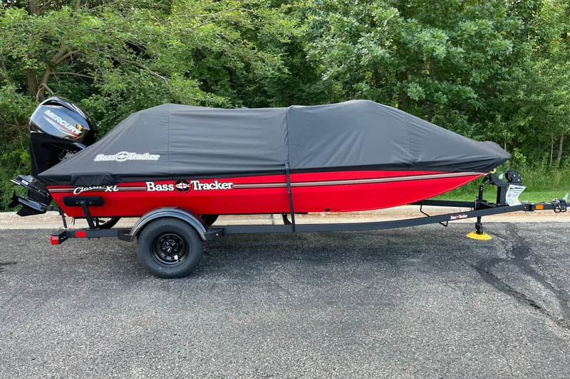 Slide: The Image of 2027 Tracker Bass Tracker Classic XL boat with cover on trailer, parked outdoors. - 22