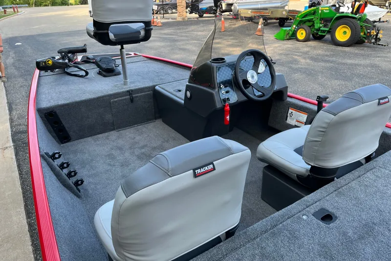 Slide: The Image of 2027 Tracker Bass Tracker Classic XL boat interior with steering wheel and seating. - 13