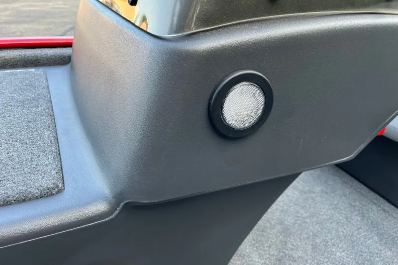 Slide: The Image of 2027 Tracker Bass Tracker Classic XL interior detail with speaker and carpeted surface. - 17