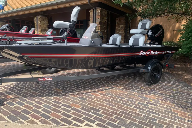 The Image of 2027 Tracker Bass Tracker Classic XL boat on a trailer, parked on brick pavement. - 0