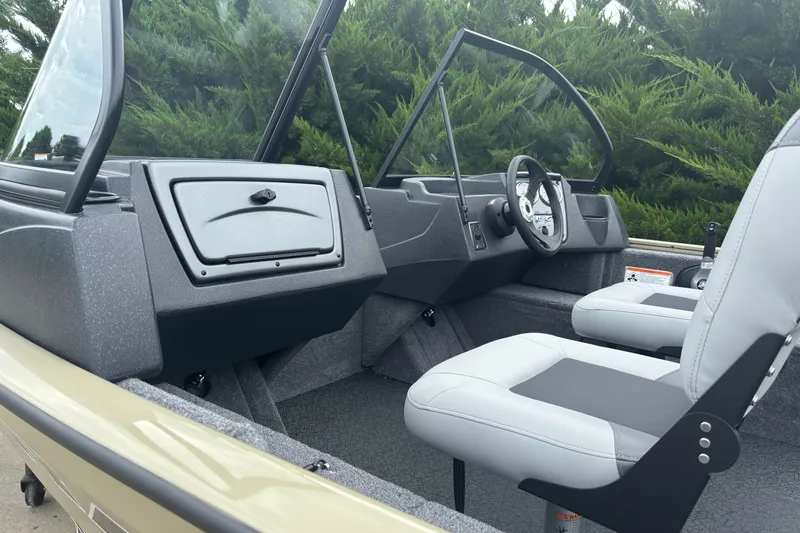 Slide: The Image of 2027 Tracker Super Guide V-16 SC boat interior with steering wheel and seating. - 13