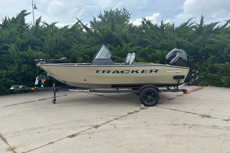 The Image of 2027 Tracker Super Guide V-16 SC boat on trailer, parked outdoors. - 0