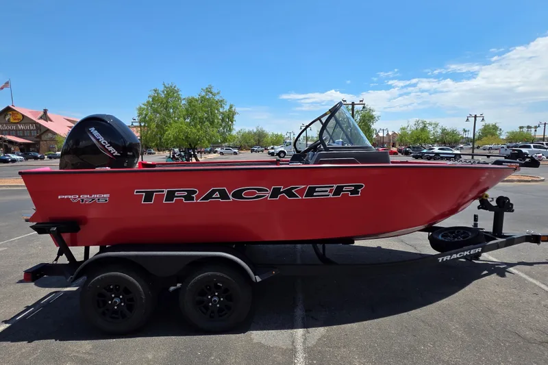The Image of 2027 Tracker Pro Guide V-175 Combo boat on trailer, parked outdoors. - 0