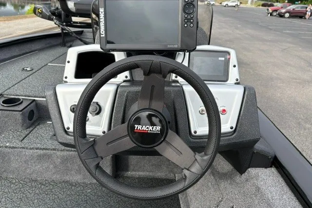 Slide: The Image of Steering wheel and dashboard of 2027 Tracker Pro Team 175 boat with navigation system. - 18