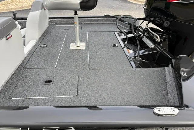 Slide: The Image of 2027 Tracker Pro Team 175 boat deck with seating and motor, featuring sleek design and storage compartments. - 25