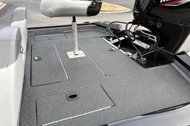 Slide: The Image of 2027 Tracker Pro Team 175 boat deck with seating and motor, showcasing storage compartments. - 24