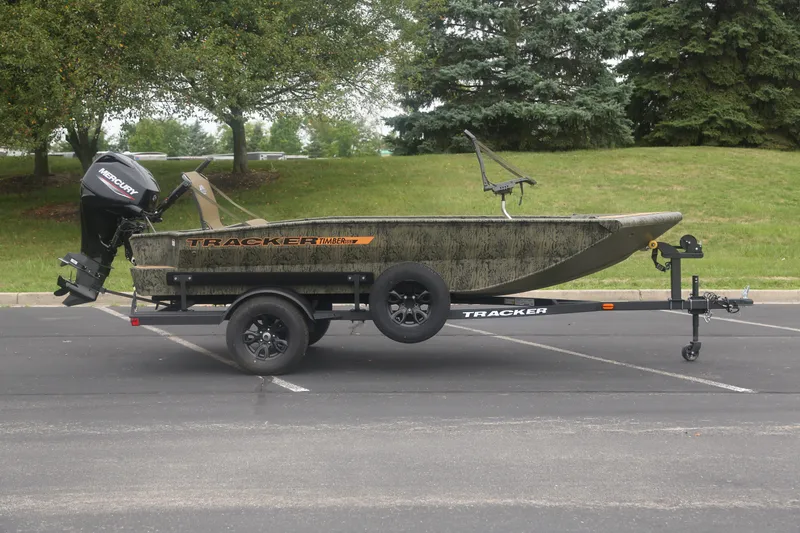 The Image of 2027 Tracker Grizzly 1553 Timber boat on trailer in parking lot. - 0