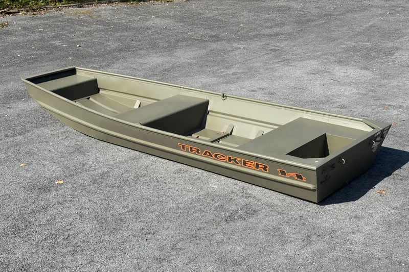 The Image of 2027 Tracker Grizzly 14 Jon boat on pavement, showcasing its sturdy design. - 0