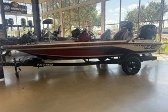 The Image of 2027 Nitro Z18 XL Pro boat displayed indoors with trailer, featuring sleek design and modern features. - 0