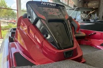 Slide: The Image of 2027 Nitro Z18 XL Pro boat in showroom, featuring sleek red design. - 2