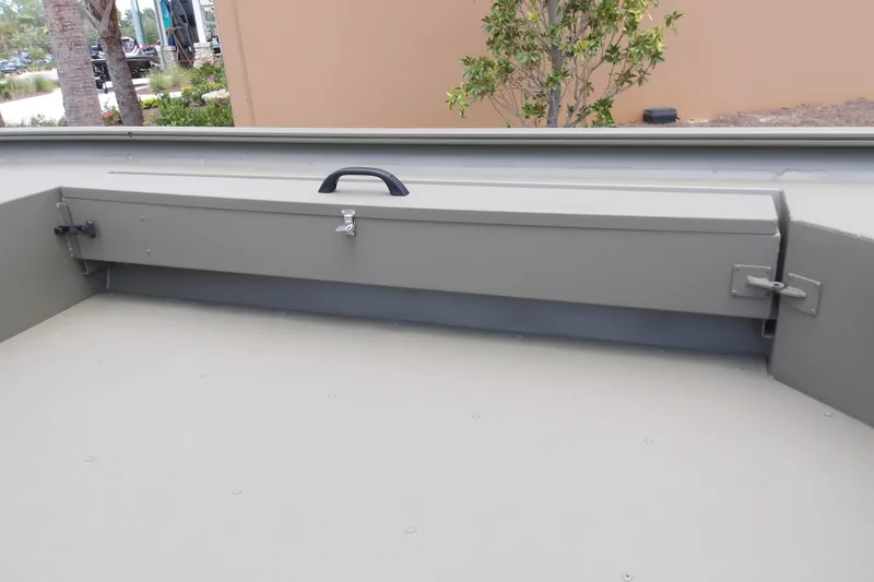 Slide: The Image of 2027 Tracker Grizzly 1654 T Sportsman boat storage compartment with lock and handle. - 13