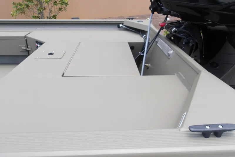 Slide: The Image of 2027 Tracker Grizzly 1654 T Sportsman boat interior with storage compartment and motor. - 15