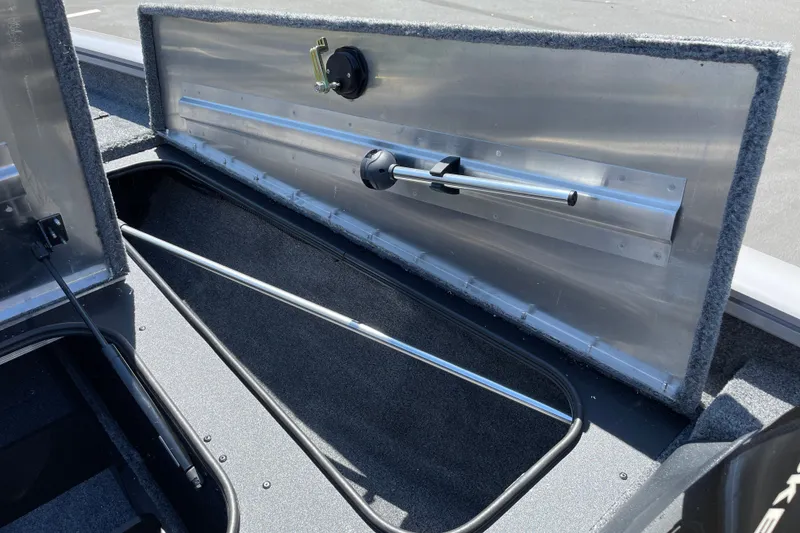 Slide: The Image of Open storage compartment in 2027 Tracker Pro Team 175 boat, showcasing interior features. - 27