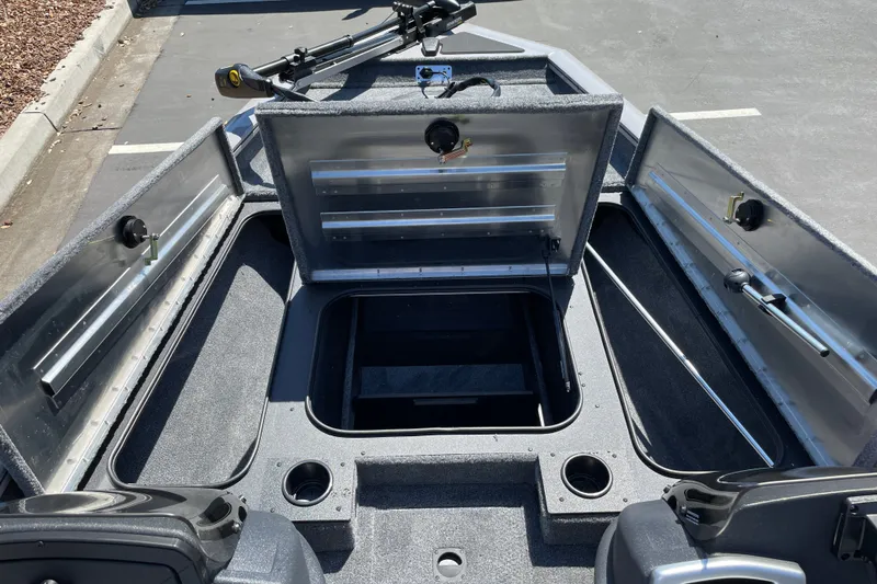 Slide: The Image of 2027 Tracker Pro Team 175 boat interior with open storage compartments and fishing rod holders. - 22