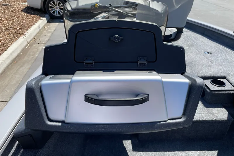 Slide: The Image of 2027 Tracker Pro Team 175 boat dashboard with storage compartment and cup holder. - 18