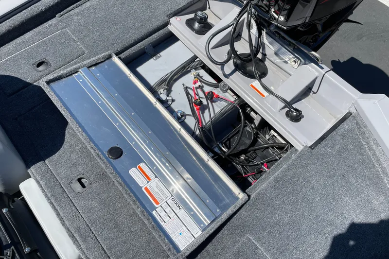 Slide: The Image of Open battery compartment of 2027 Tracker Pro Team 175 boat, showing wiring and components. - 13
