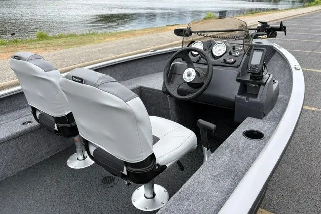 Slide: The Image of 2027 Tracker Super Guide V-16 SC boat interior with steering console and seating. - 25