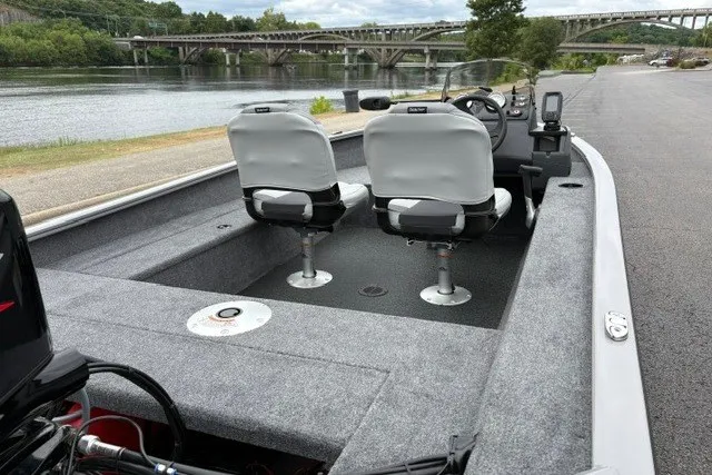 Slide: The Image of 2027 Tracker Super Guide V-16 SC boat with dual seats by a scenic river. - 13