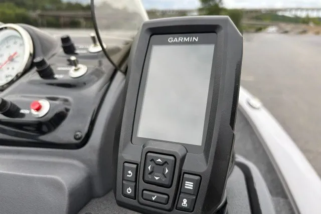 Slide: The Image of Garmin device on 2027 Tracker Super Guide V-16 SC boat dashboard with controls. - 18