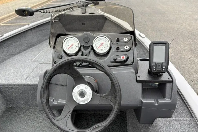 Slide: The Image of Dashboard of 2027 Tracker Super Guide V-16 SC boat with steering wheel and gauges. - 19