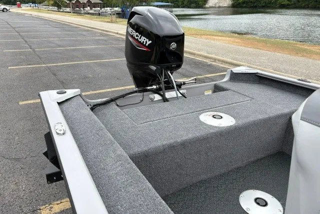 Slide: The Image of 2027 Tracker Super Guide V-16 SC boat with Mercury engine, parked near a lake. - 24