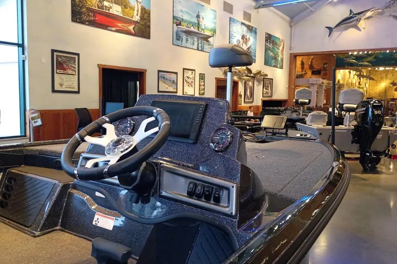Slide: The Image of 2027 Nitro Z18 XL Pro boat interior in showroom with steering wheel and control panel. - 3