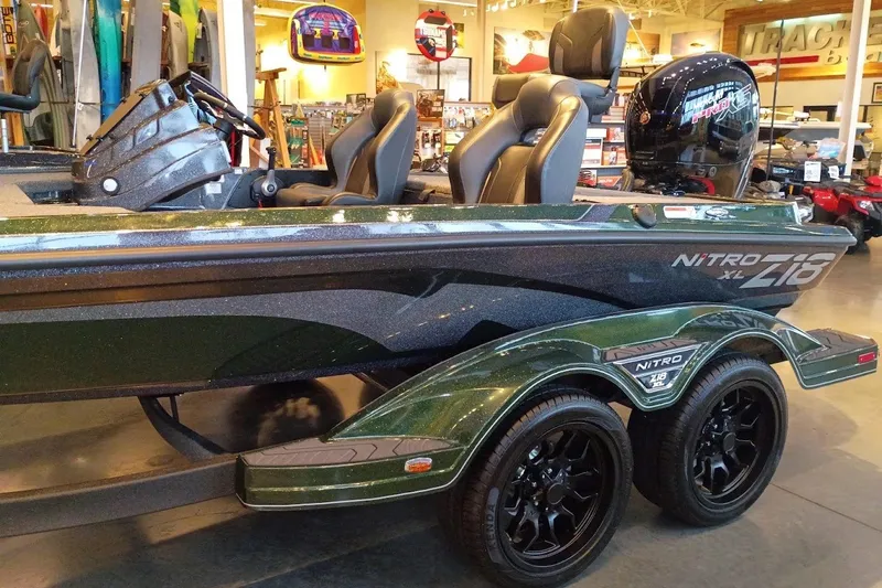 Slide: The Image of 2027 Nitro Z18 XL Pro boat in showroom, featuring sleek design and dual axle trailer. - 1