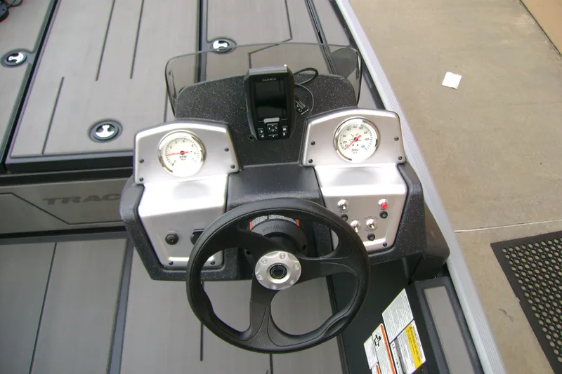 Slide: The Image of 2027 Tracker Pro 170 boat dashboard with steering wheel and gauges. - 15