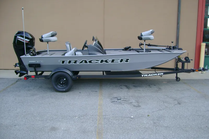 The Image of 2027 Tracker Pro 170 fishing boat on trailer, featuring Mercury outboard motor. - 0