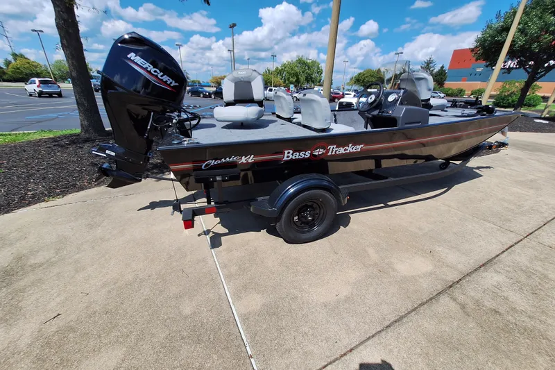 The Image of 2027 Tracker Bass Tracker Classic XL boat on trailer in parking lot. - 0