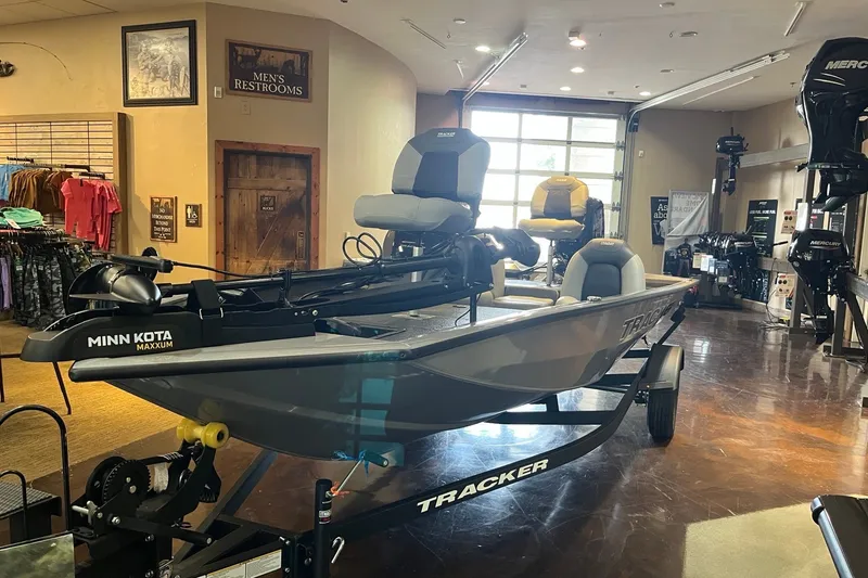 The Image of 2027 Tracker Pro Team 175 boat displayed in a showroom with fishing gear. - 0