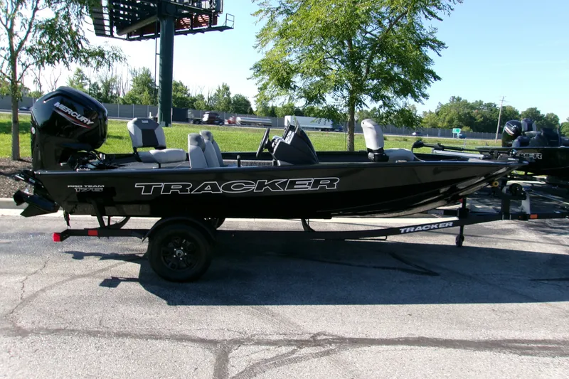 The Image of 2027 Tracker Pro Team 175 boat on trailer, parked outdoors. - 0