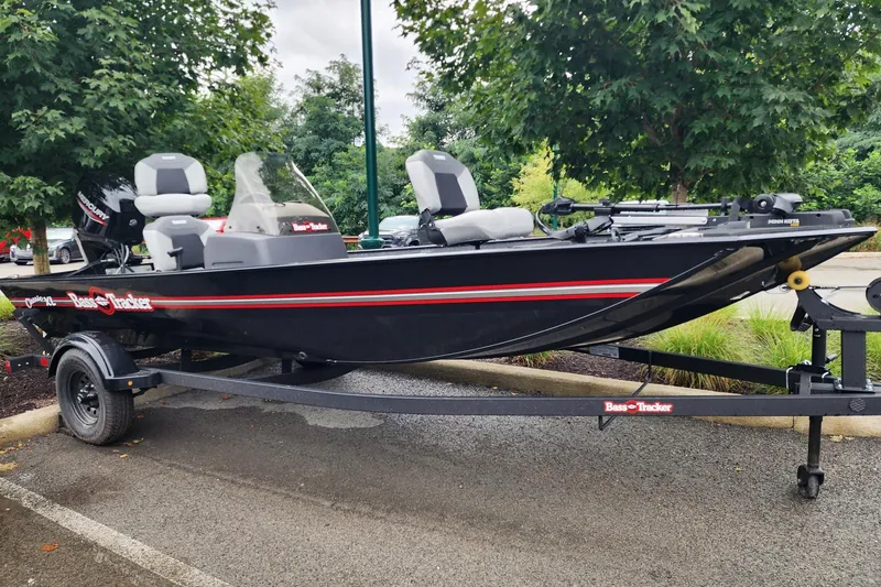 The Image of 2027 Tracker Bass Tracker Classic XL boat on trailer, parked outdoors. - 0