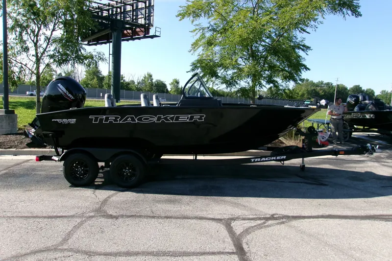The Image of 2027 Tracker Pro Guide V-175 Combo boat on trailer, parked outdoors. - 0