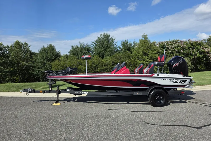 The Image of 2027 Nitro Z18 XL Pro boat on trailer, parked outdoors under blue sky. - 0