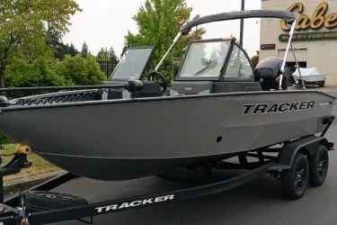 The Image of 2027 Tracker Pro Guide V-175 Combo boat on trailer, parked outdoors. - 0