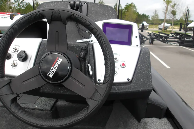Slide: The Image of 2027 Tracker Pro Team 175 boat dashboard with steering wheel and control panel. - 17