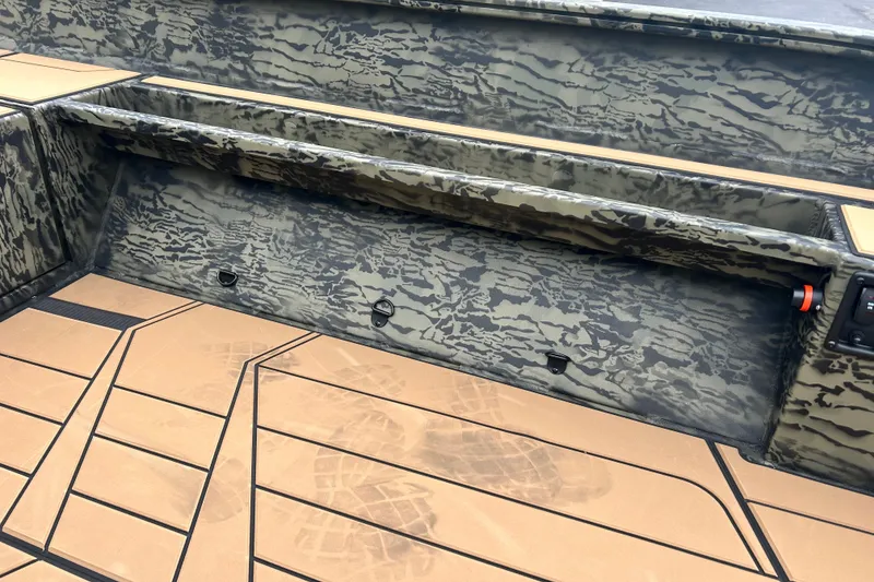 Slide: The Image of Interior of 2027 Tracker Grizzly 1553 Timber boat with camouflage design and tan flooring. - 13