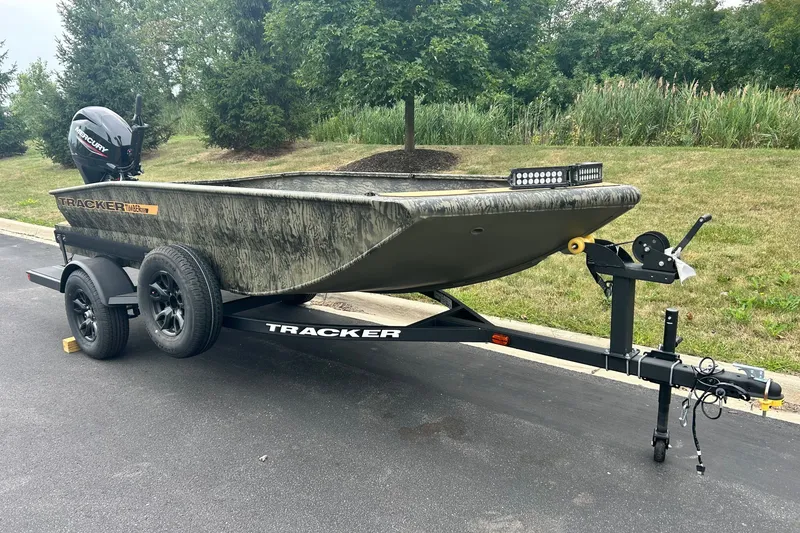 The Image of 2027 Tracker Grizzly 1553 Timber boat on trailer, parked on a paved road. - 0