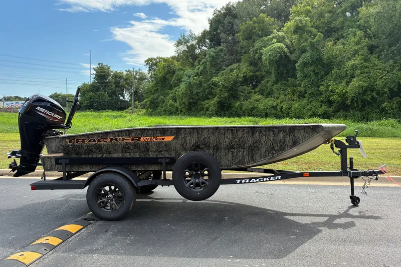 The Image of 2027 Tracker Grizzly 1553 Timber boat on trailer, parked outdoors. - 0