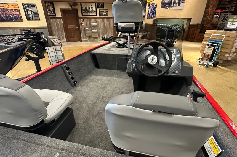 Slide: The Image of 2027 Tracker Bass Tracker Classic XL boat interior with steering wheel and seating. - 14