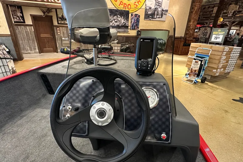 Slide: The Image of 2027 Tracker Bass Tracker Classic XL boat dashboard with steering wheel and Garmin device. - 16