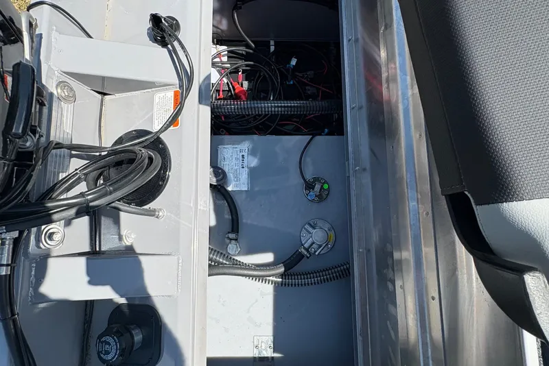 Slide: The Image of 2027 Tracker Pro Team 175 boat interior showing storage compartment and wiring. - 19