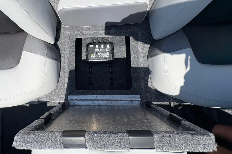 Slide: The Image of Interior view of 2027 Tracker Pro Team 175 boat, showcasing storage compartment and seating. - 18