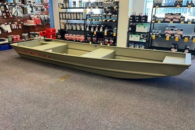 The Image of 2027 Tracker Grizzly 14 Jon boat displayed in a store with marine supplies. - 0