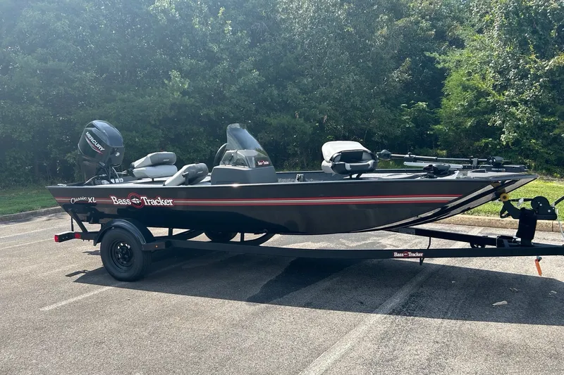 The Image of 2027 Tracker Bass Tracker Classic XL boat on trailer in parking lot. - 0