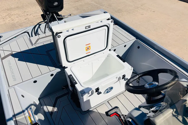 Slide: The Image of 2027 Tracker Bass Tracker Classic CC boat interior with open cooler and steering wheel. - 24